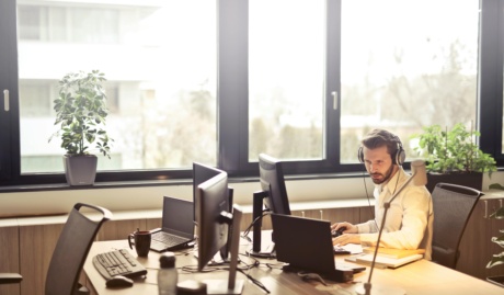 Man Sitting At A Desk Infront Of A Computer