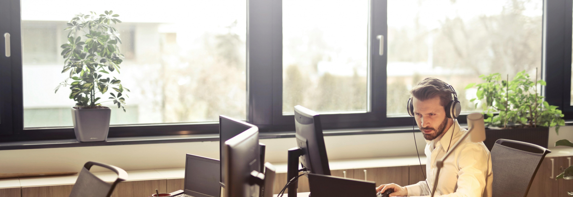 Man Sitting At A Desk Infront Of A Computer